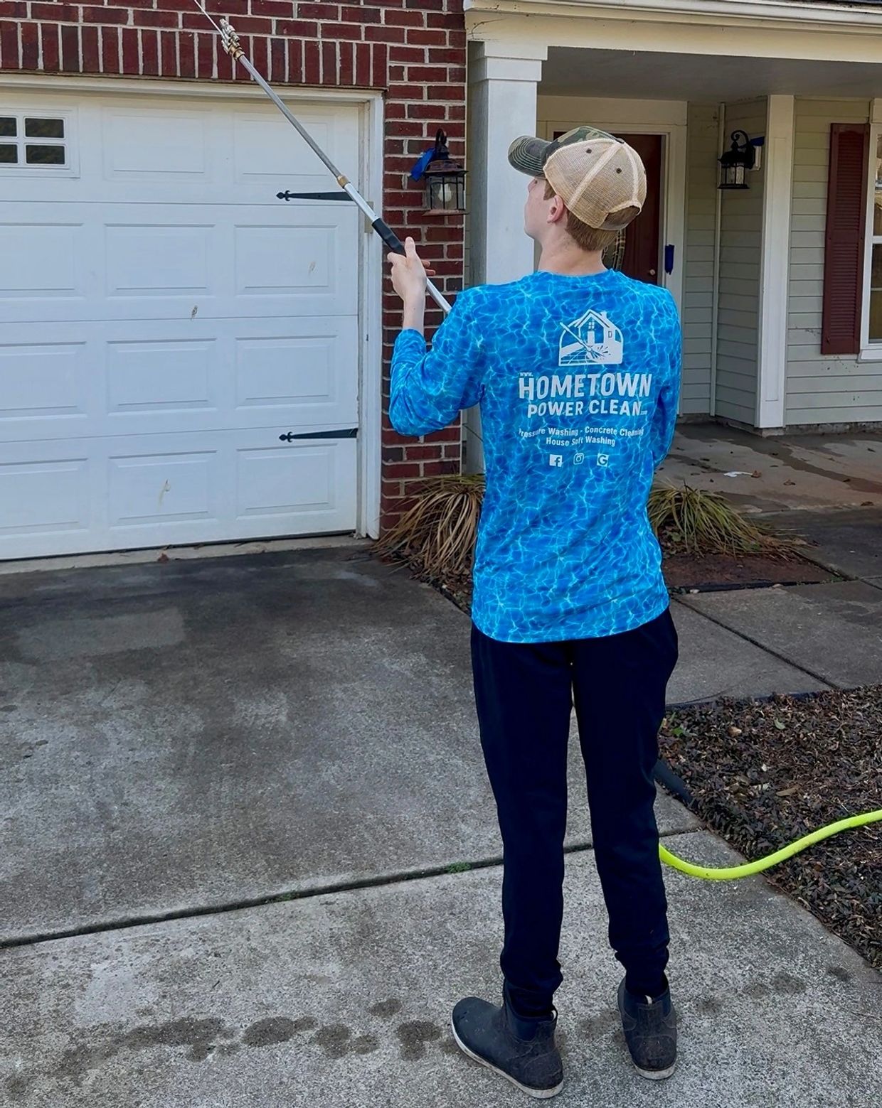 Person washing a house.