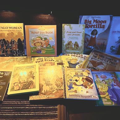 A collection of children's books displayed on a table.