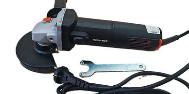 Electric angle grinder with a wrench and power cord.