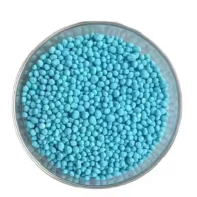 Blue granular substance in a round transparent container.