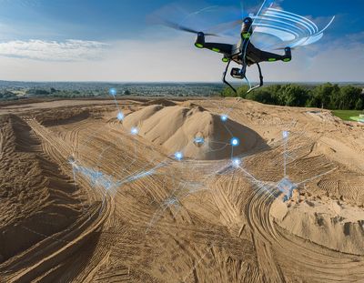 A lidar drone scanning a sand pile, collecting vector points to calculate the volume of the pile.