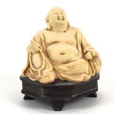 Laughing Buddha statue sitting on a black pedestal.
