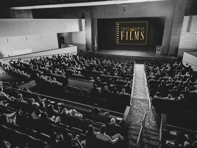 A vintage black and white photo of a crowded cinema theater.