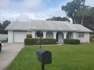 A single-story suburban house with a front lawn and mailbox.
