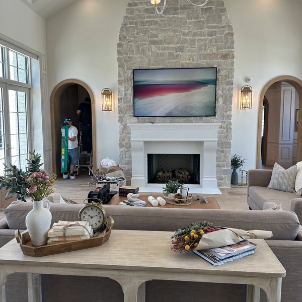 Modern living room with stone fireplace and elegant decor.