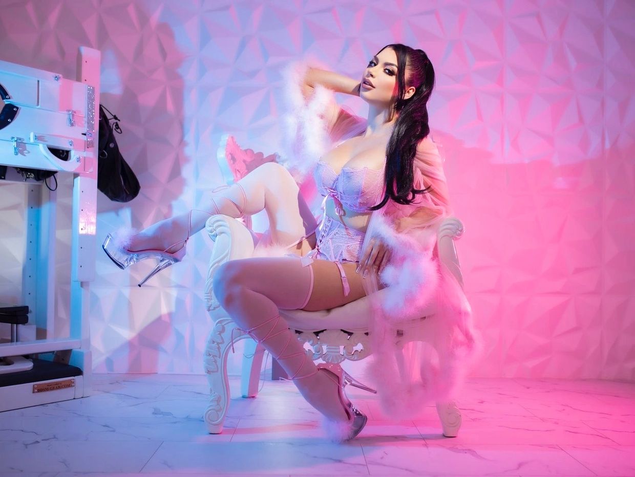 spoiled latina domina showcasing her long legs in all pink and heels.