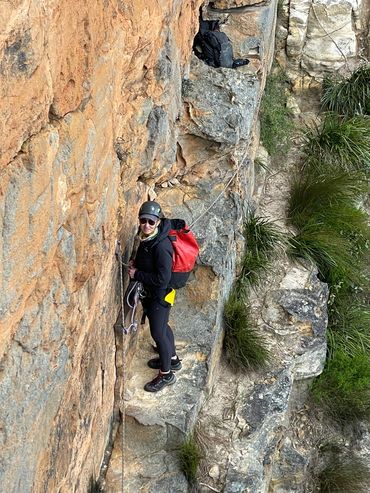 Abseil participant on a cliff ledge in the Blue Mountains