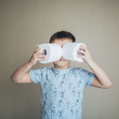 Child holding toilet roll as eyes