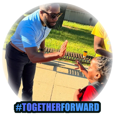 Man giving a high-five to a smiling child outdoors.