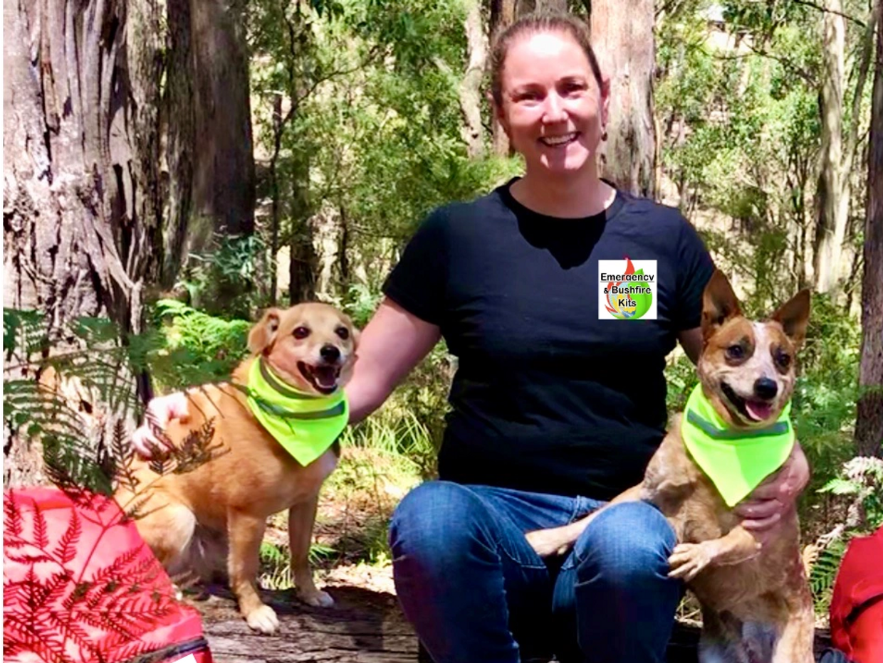 survival kits, dogs with high vis scarves, woman smiling, safety gear, emergency kits