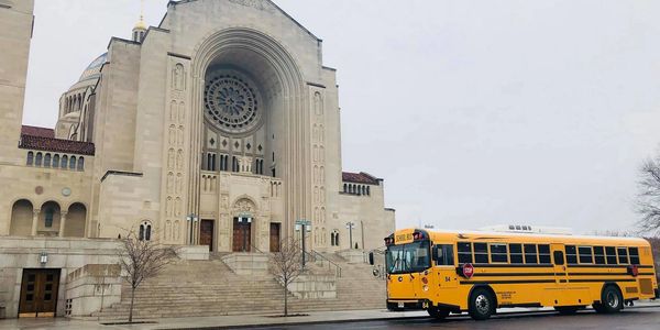 School bus parked in front of Basillica