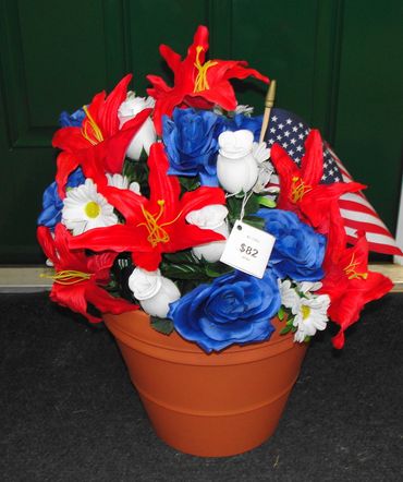 12" Clay Pot with Red Lilies, White Rosebuds, Daisies, Blue Roses & Flag
