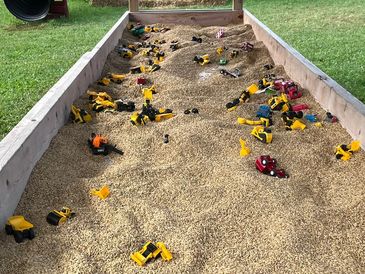 Barley play with toy construction vehicles.