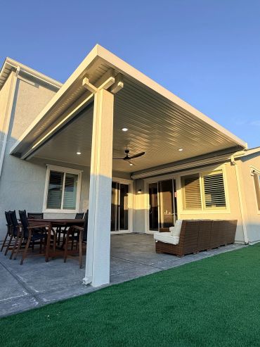 Modern backyard patio with seating and dining area.