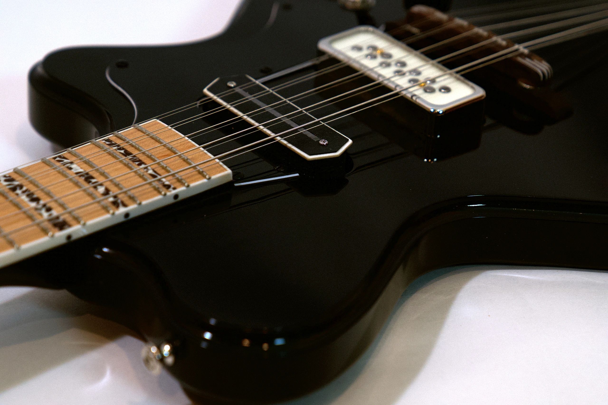 Close-up of a black electric guitar.