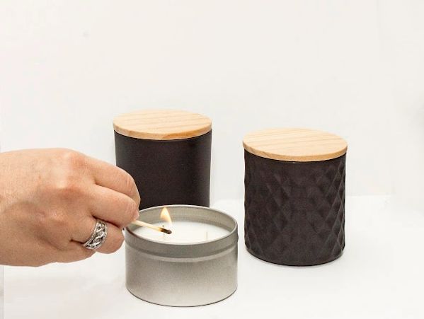 Product photo of scented candles in a metallic container