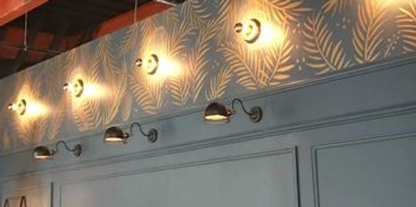 Wall with decorative lights and patterned wallpaper.