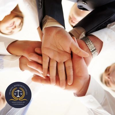 Business team stacking hands in unity, symbolizing teamwork and collaboration.