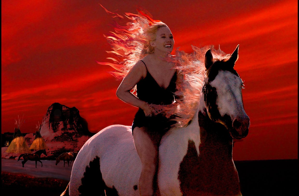 Woman with flowing hair rides a horse against a vivid red sunset backdrop.