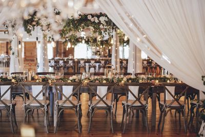 Elegant wedding reception table with floral and candle decorations.