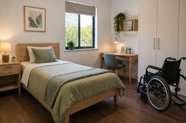 Cozy bedroom with a single bed and wheelchair accessible setup.