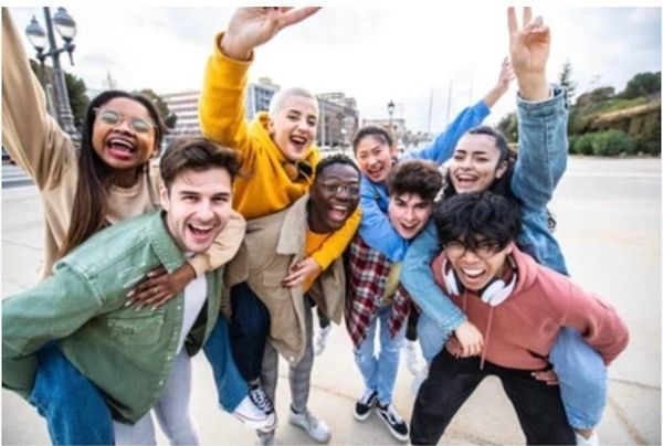 A group of diverse young adults cheering