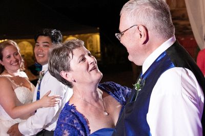 Mother and Father of the Bride and Father dancing in formal attire