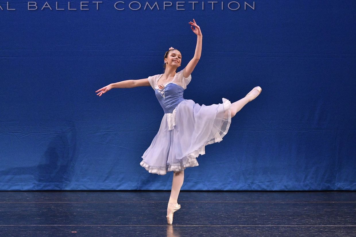 Ballet dancer performing on stage.