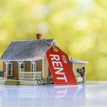 Model house with a 'For Rent' tag.