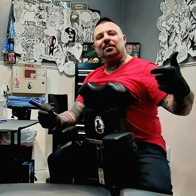 Inkslinger Erick, owner, custom tattoo artist, and tattoo cover-up king