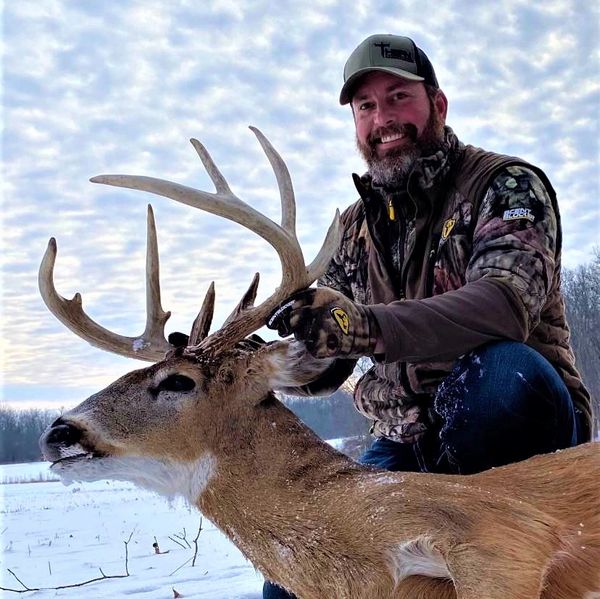 Aaron Zimmerman from Major League Bowhunter showing off his buck taken over MaxRack® deer mineral. 