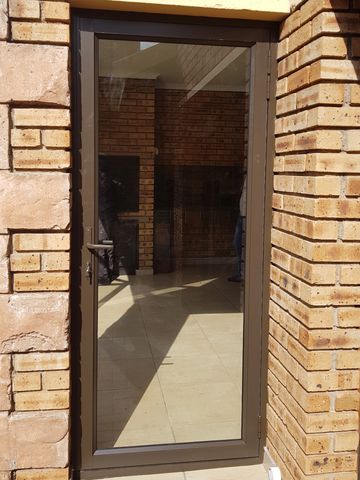 Bronze Aluminium Single Hinged Door with Clear 6.38mm Laminated Safety Glass