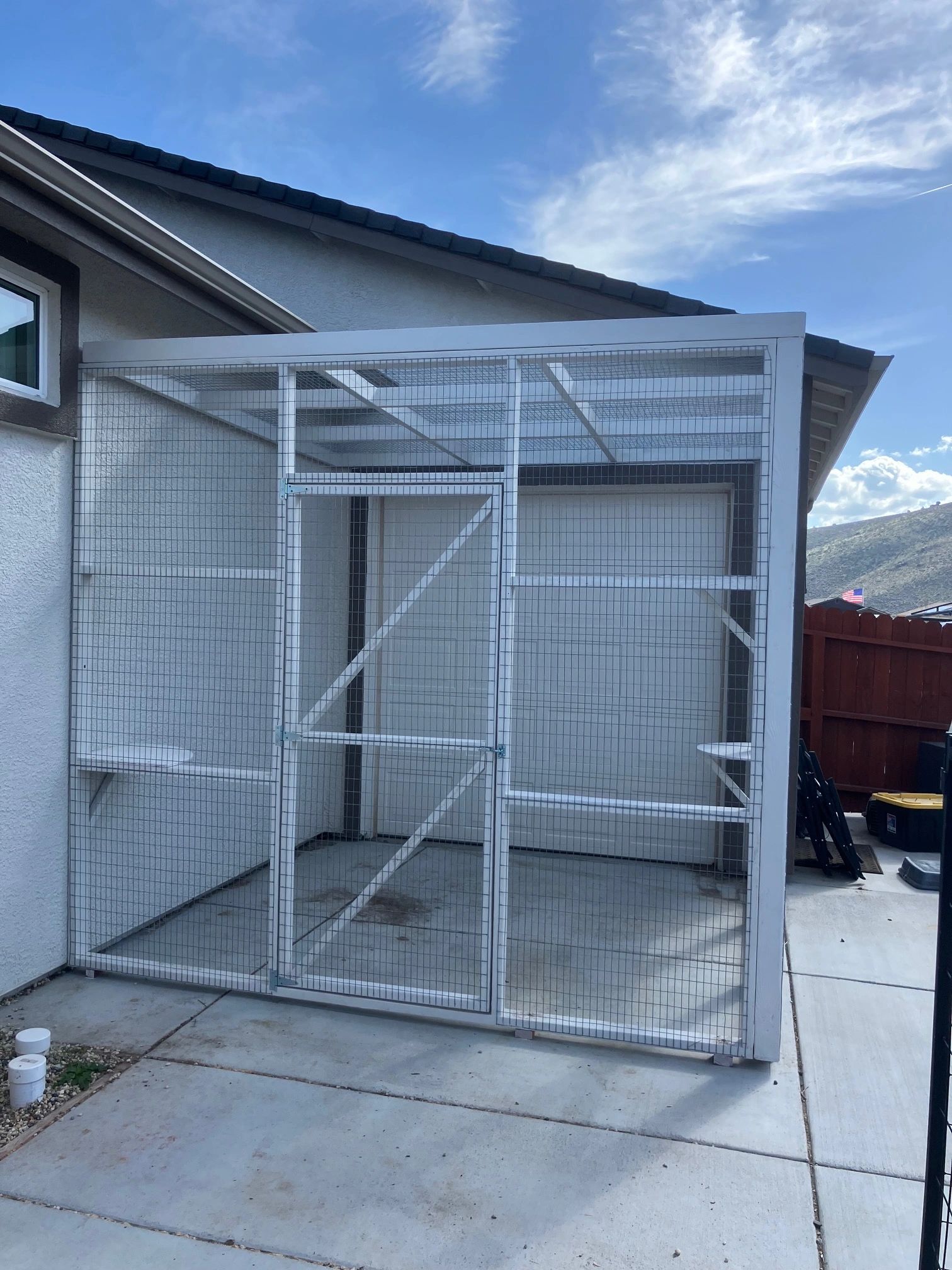 A WELL-BUILT CATIO.  THIS GARAGE DOOR CATIO ALLOWS THE OWNER TO RAISE AND LOWER THE GARAGE DOOR.