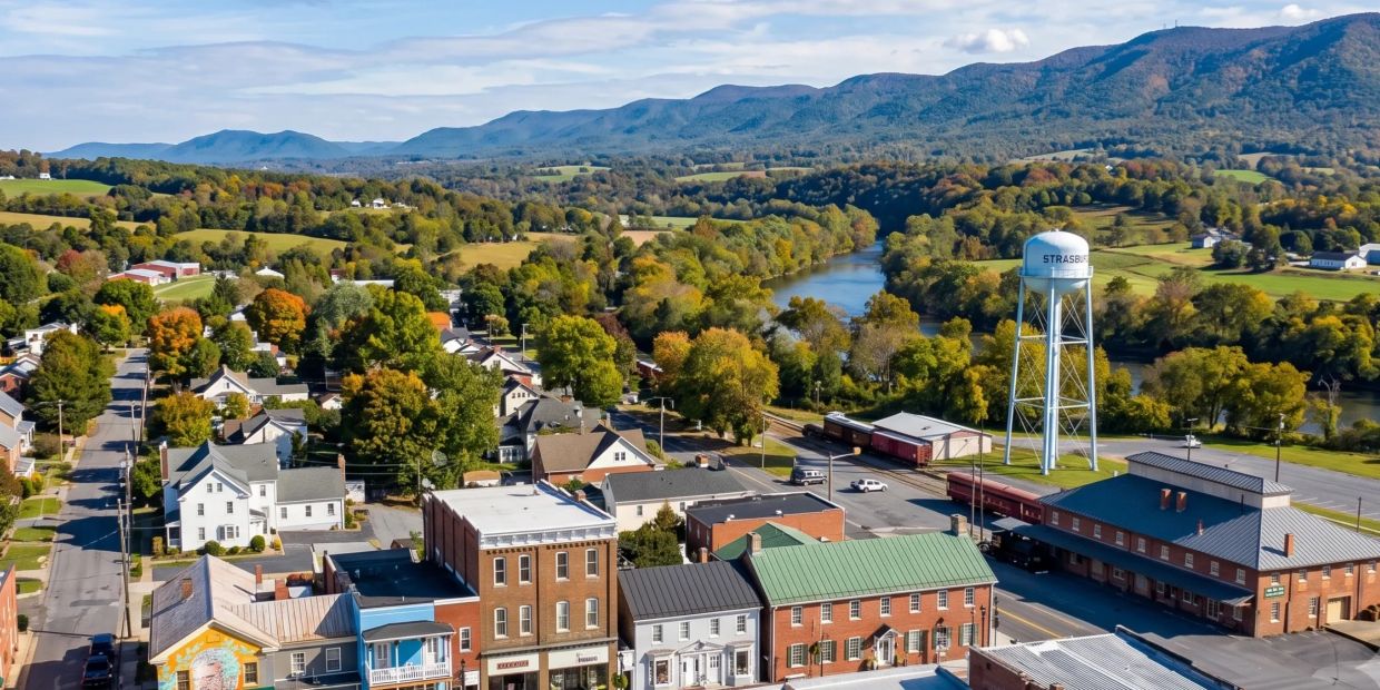 Small town with river and mountains in the background.