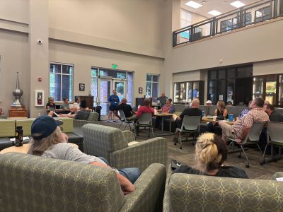 People gathered in a spacious lounge area during a meeting.