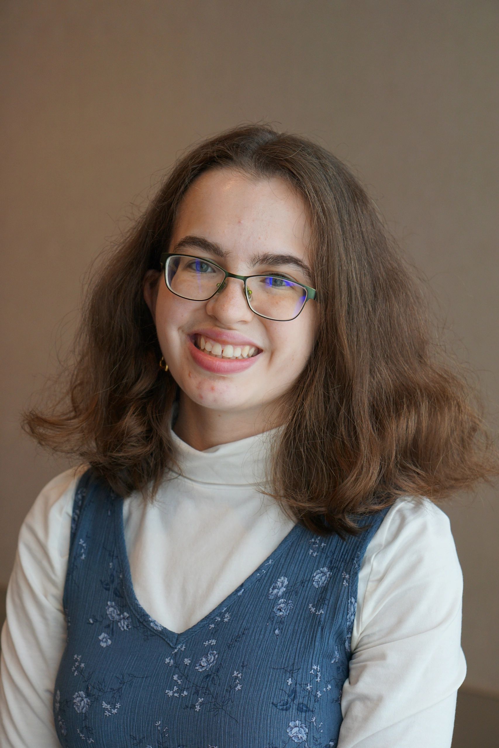 a photo of Elizabeth Hart. She is staring into the distance and smiling.