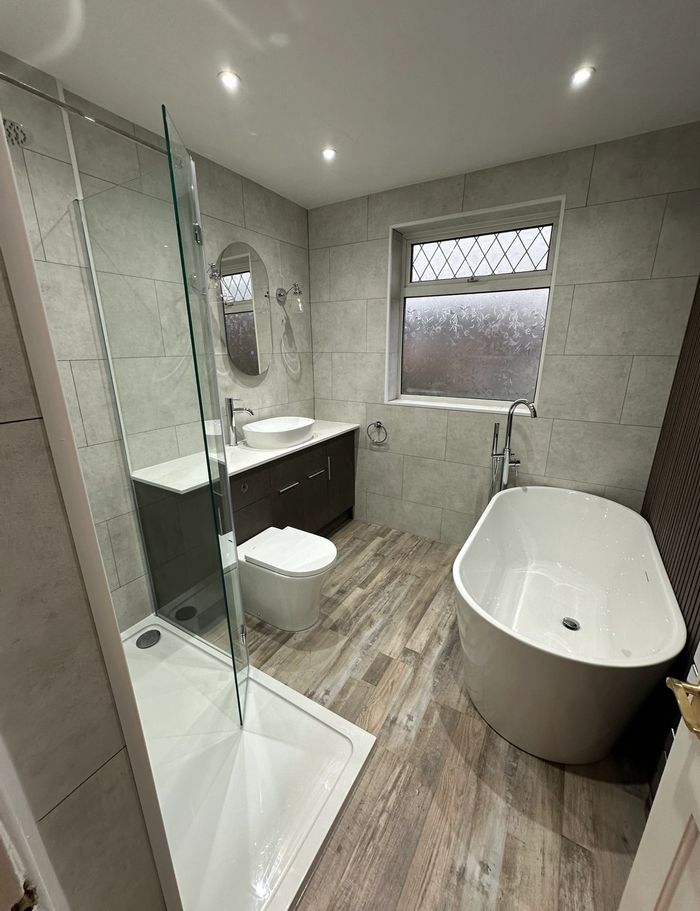 Modern  Bathroom with both Bath and Walk-in shower, 
Solid tile cladding with a Slat wall feature.