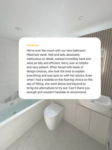 Modern bathroom with bathtub, toilet, and vanity unit.