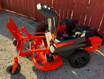 Red riding lawn mower parked outside.