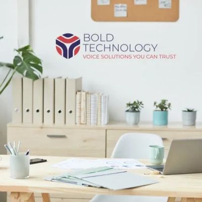 Office space with the Bold Technologies logo on the wall