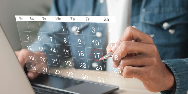 A client virtually schedules an appointment by circling a date on a calendar.