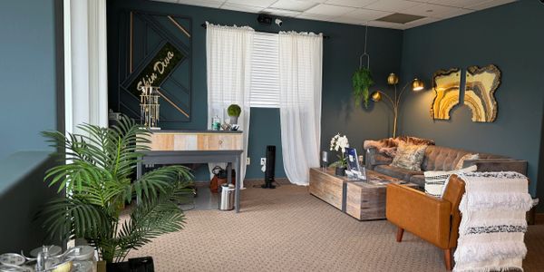 A cozy, stylish living room with blue walls and modern furniture.