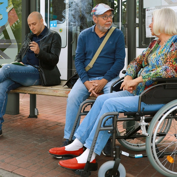 People sitting at a bus stop.