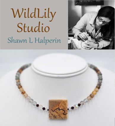 Artisan Shawn L Halperin crafting unique jewelry at WildLily Studio.
