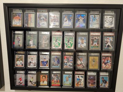 Framed collection of vintage baseball cards displayed on a wall.