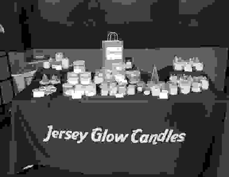 Jersey Glow Candles display with various scented candles and wax melts.