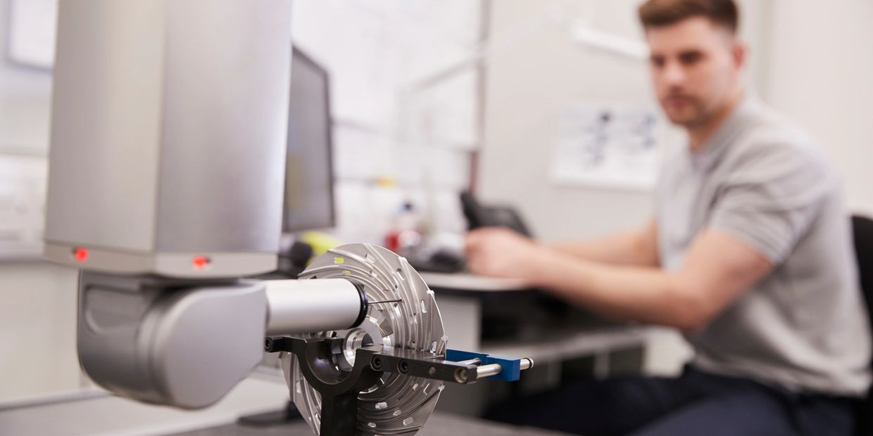 Man operating precision measurement equipment in a lab.