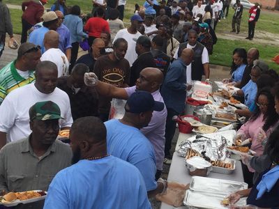 People enjoying a large outdoor buffet.