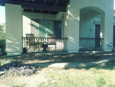 Ornamental iron courtyard fence with decorative scrolls and circles. Peoria, Arizona.