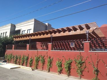 Ornamental iron perimeter fence with decorative spear tops. Cafe Monarch, Scottsdale, Arizona. 